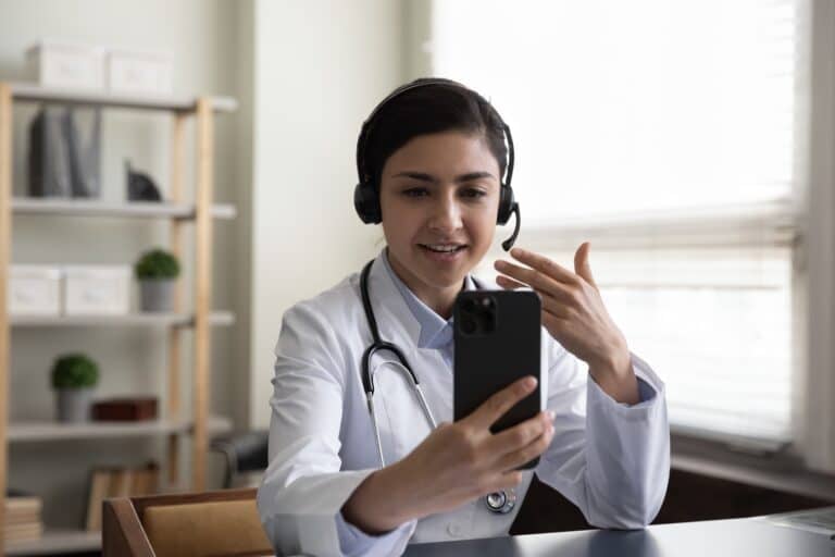 female healthcare professional using online advice portal on her phone