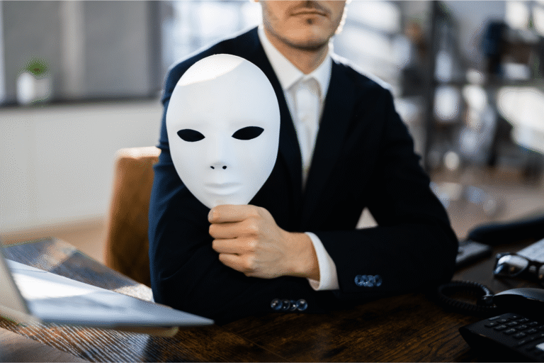 Concept of data quality issues in market research - man in suit holds a white mask in front of his body