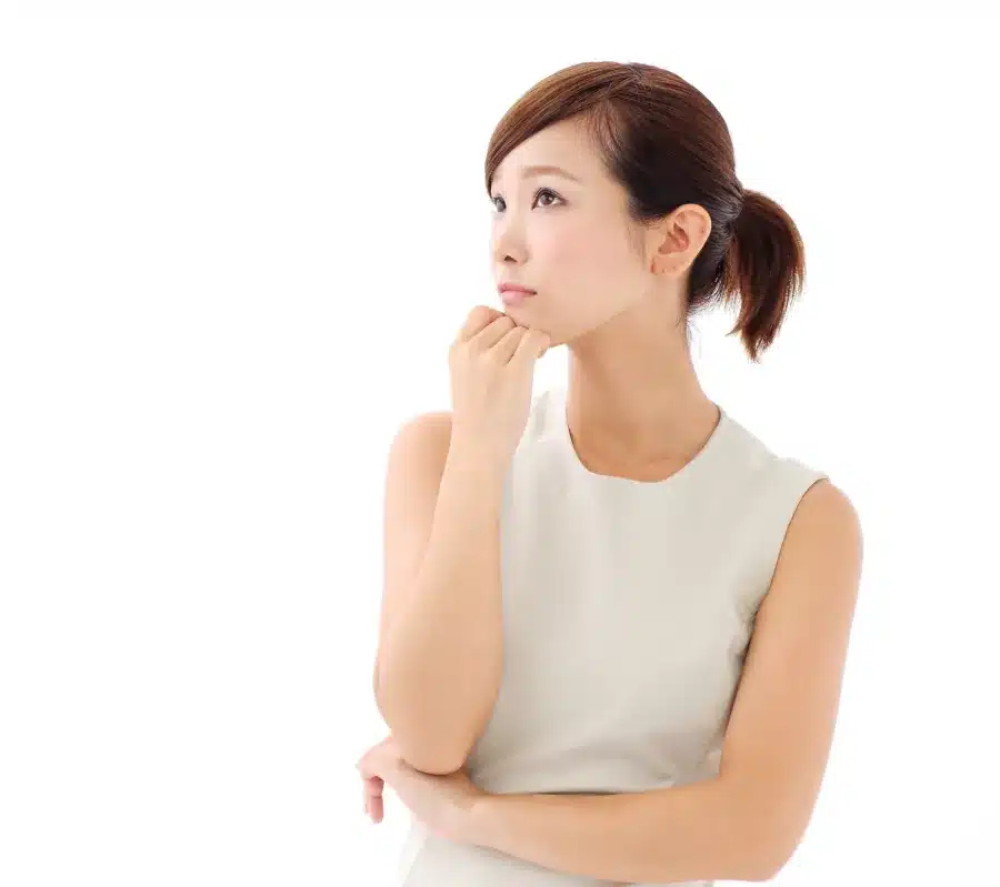 Asian woman in white dress looking puzzled as she wonders about the meaning of a market research term