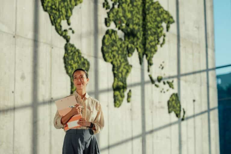 Smiling businesswoman holding a clipboard, thinking about multi-country market research